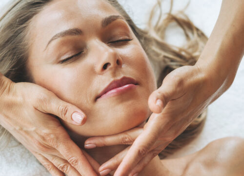Photo of a woman receiving a facial at a spa